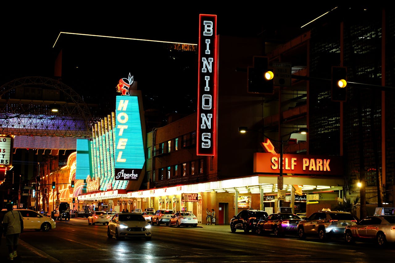Neon lights illuminate Fremont Street, showcasing Binion's Hotel in Las Vegas at night.